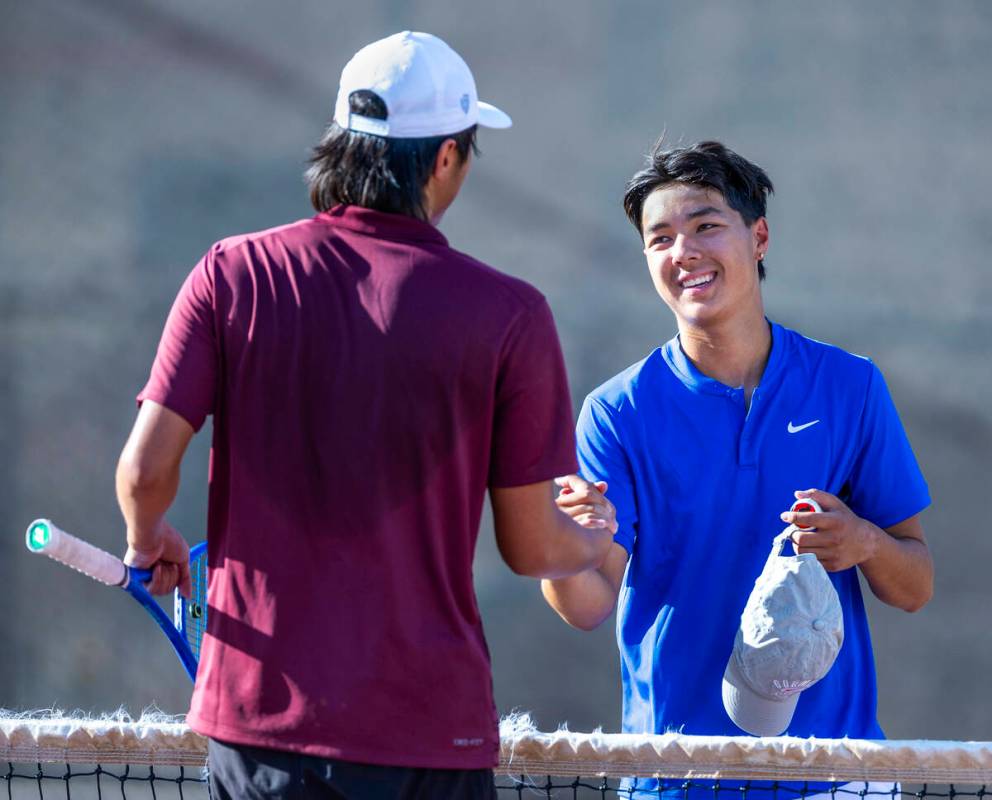 Faith Lutheran's Alpha Vonxaiburana shakes hands with Bishop Gorman's Shawn DeMilliano followin ...
