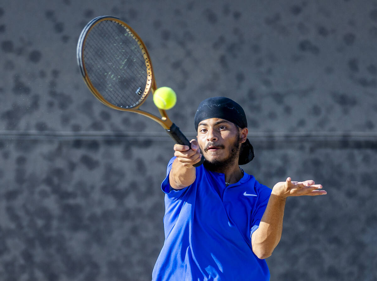 Bishop Gorman's Aikus Chadha returns a ball against Faith Lutheran during their doubles NIAA te ...