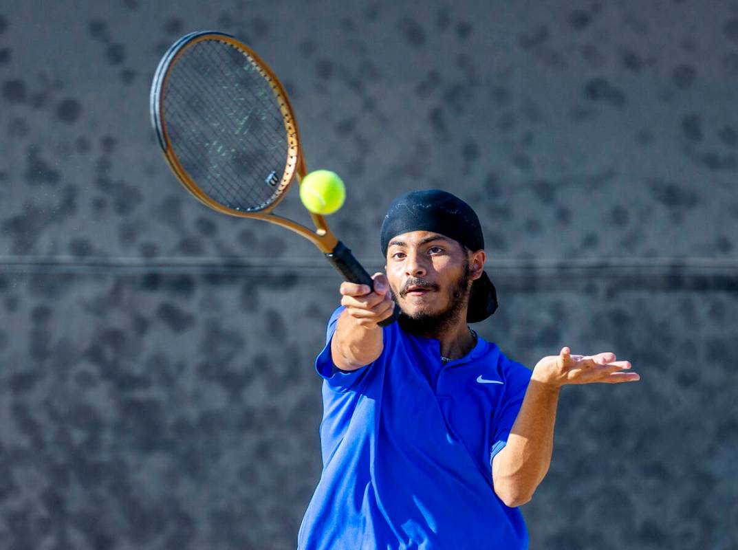 Bishop Gorman's Aikus Chadha returns a ball against Faith Lutheran during their doubles NIAA te ...