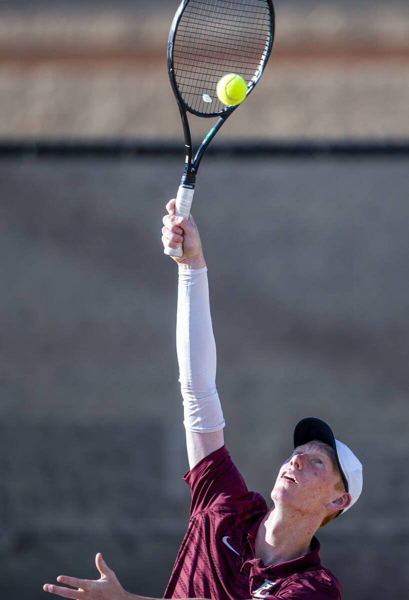 Faith Lutheran's Michael Bergen serves a ball against Bishop Gorman during their NIAA tennis ga ...