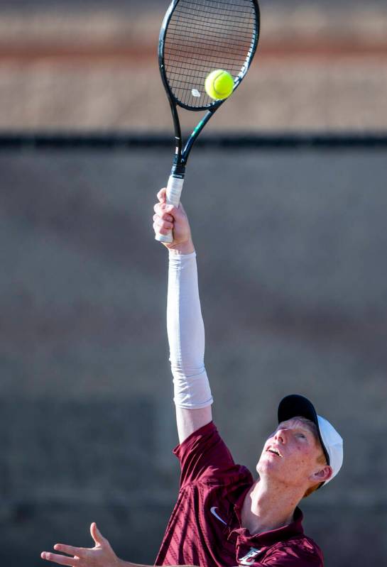 Faith Lutheran's Michael Bergen serves a ball against Bishop Gorman during their NIAA tennis ga ...
