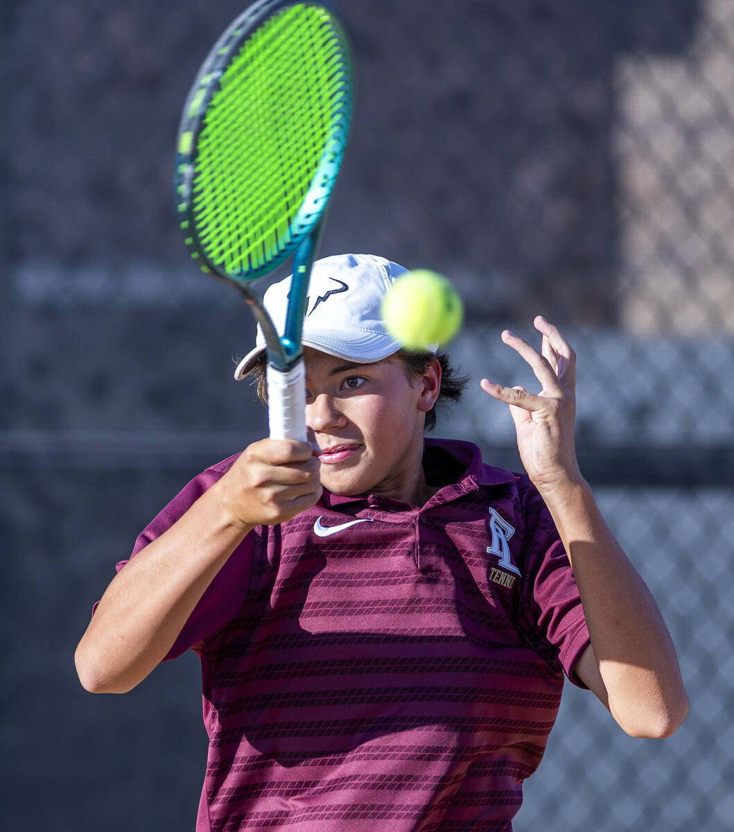 Faith Lutheran's Tyson Young returns a ball against Bishop Gorman during their singles NIAA ten ...
