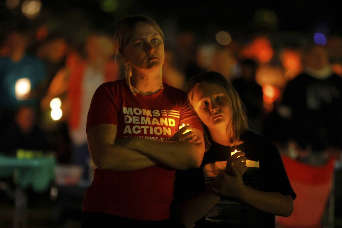 People gather at a vigil at Lynnhurst Park after a shooting at the Annunciation Catholic School ...