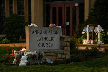 Crosses, flowers and other mementos were places by the sign at Annunciation Cathic Church at a ...
