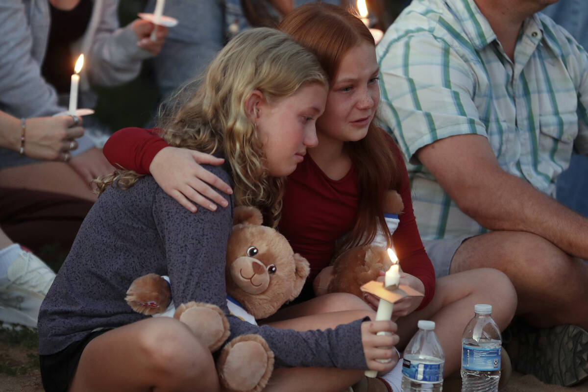 People gather at a vigil at Lynnhurst Park after a shooting at the Annunciation Catholic School ...