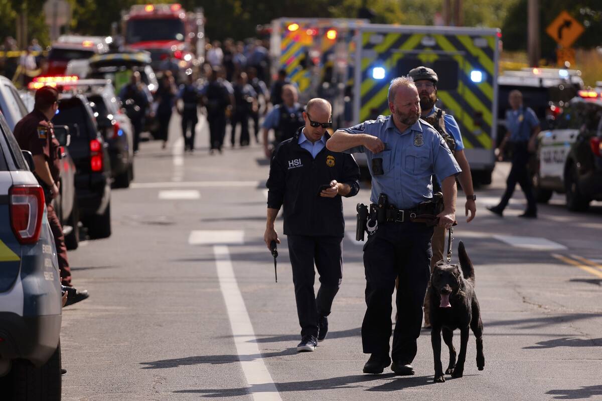 Law enforcement officers gather outside the Annunciation Church's school in response to a repor ...