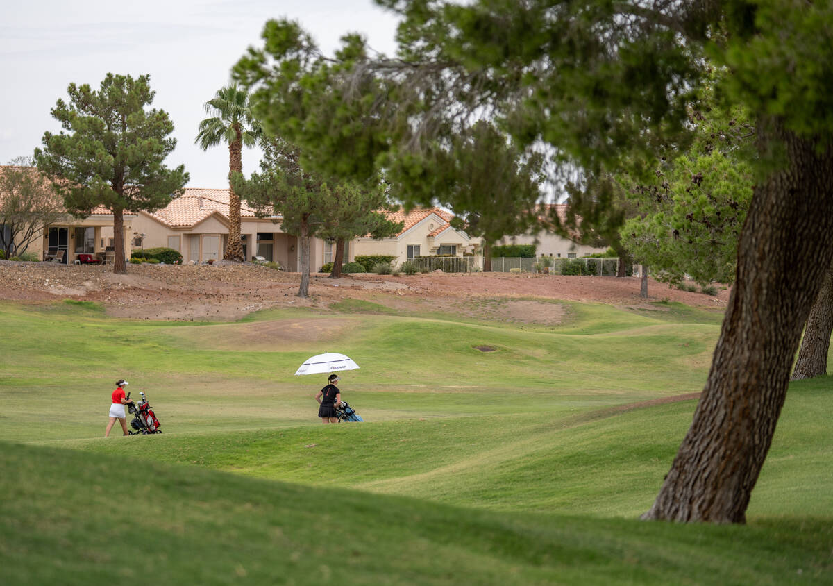 Golfers walk to the next hole during a Class 5A Desert League girls golf match at Highland Fall ...