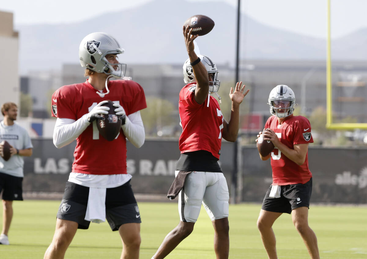 Raiders quarterbacks Kenny Pickett, left, Geno Smith and Cam Miller, right, throw passes during ...
