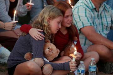 People gather at a vigil at Lynnhurst Park after a shooting at the Annunciation Catholic School ...