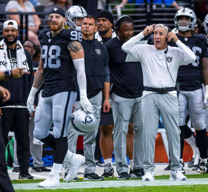 Raiders defensive end Maxx Crosby (98) and head coach Pete Carroll watch the offense move the b ...
