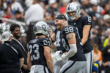 Raiders defensive end Maxx Crosby (98) and place kicker Daniel Carlson (8) congratulate Raiders ...