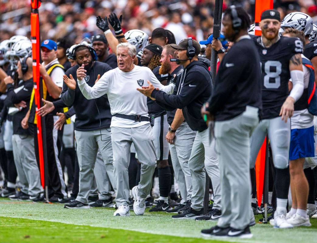 Raiders head coach Pete Carroll and his team are pumped up on the sidelines against the San Fra ...