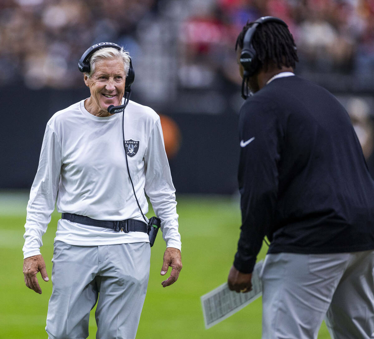 Raiders head coach Pete Carroll talks another staffer against the San Francisco 49ers during th ...