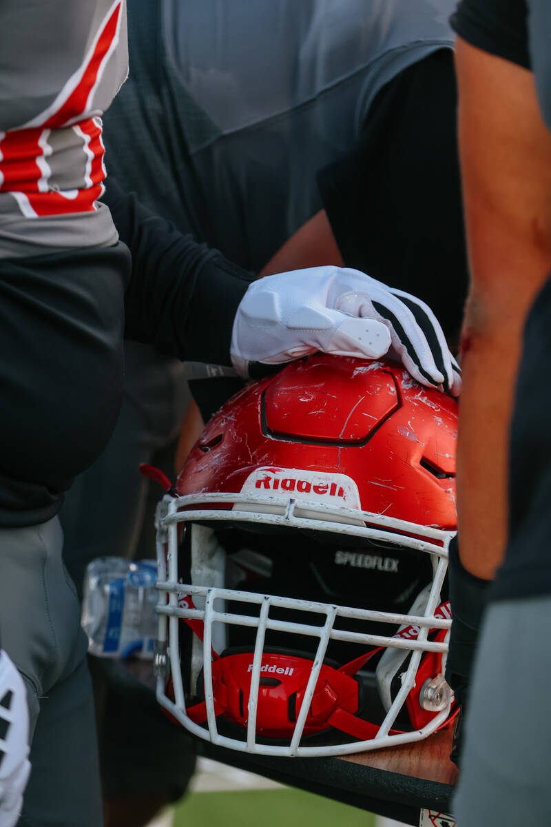 Arbor View players huddle around a table on the sidelines to review plays during the football g ...
