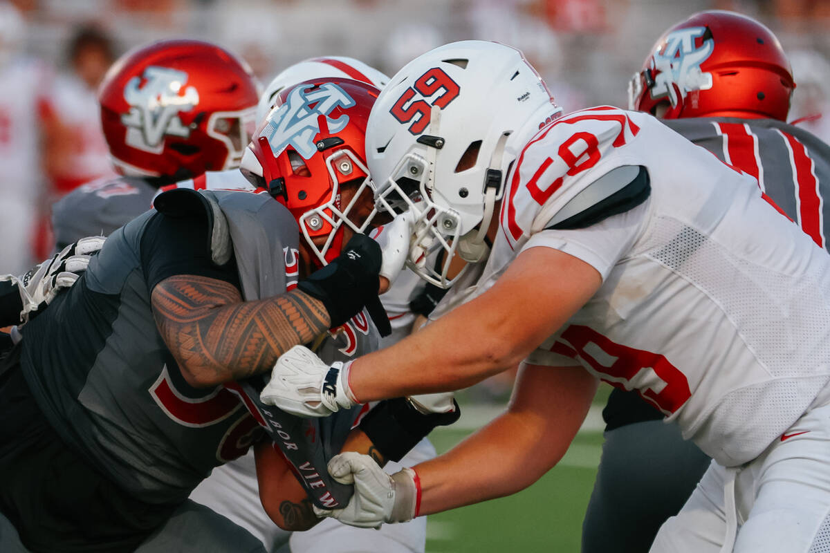 Arbor View defensive end Tani Maafala-Barbasa (58) and Millard South’s Hunter Allen (59) ...