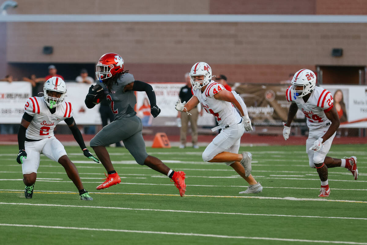 Arbor View running back Nylen Johnson (2) runs upfield, trying to avoid Millard South defenders ...