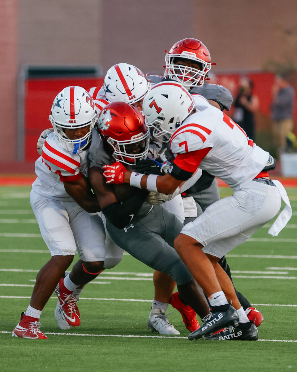 The Millard South defense takes down ballcarrier Arbor View running back Nylen Johnson (2) duri ...
