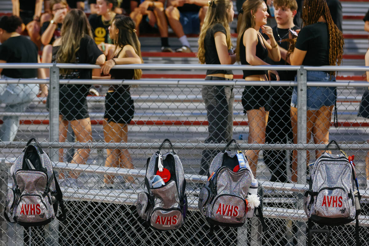 Arbor View cheerleaders’ bags hang on the fence during halftime of a football game on Fr ...