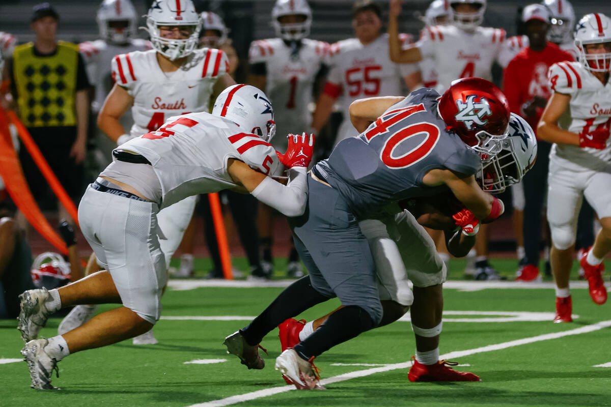 Arbor View’s Glade Hales (40) takes down Millard South running back Daxton Williams (0) ...