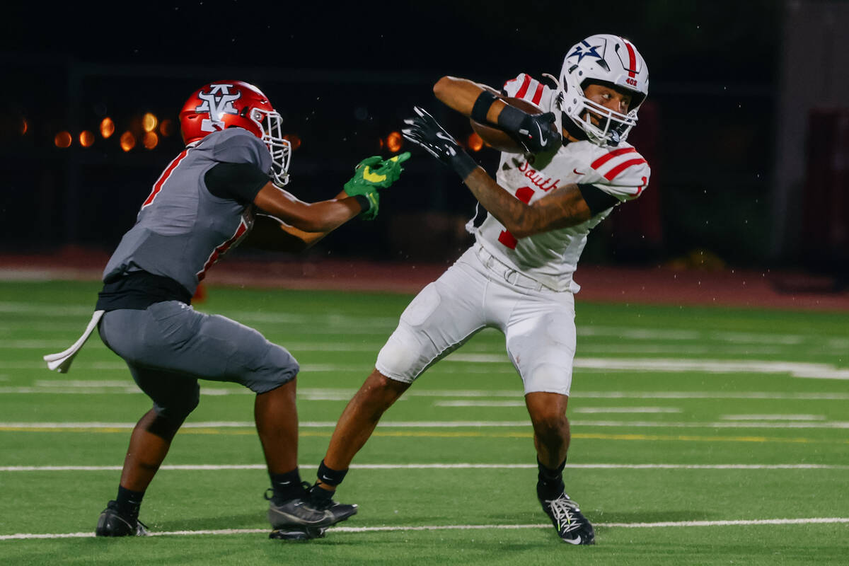 Millard South wide receiver Amarion Jackson (1) shakes off Arbor View free safety Shawn MacKey ...