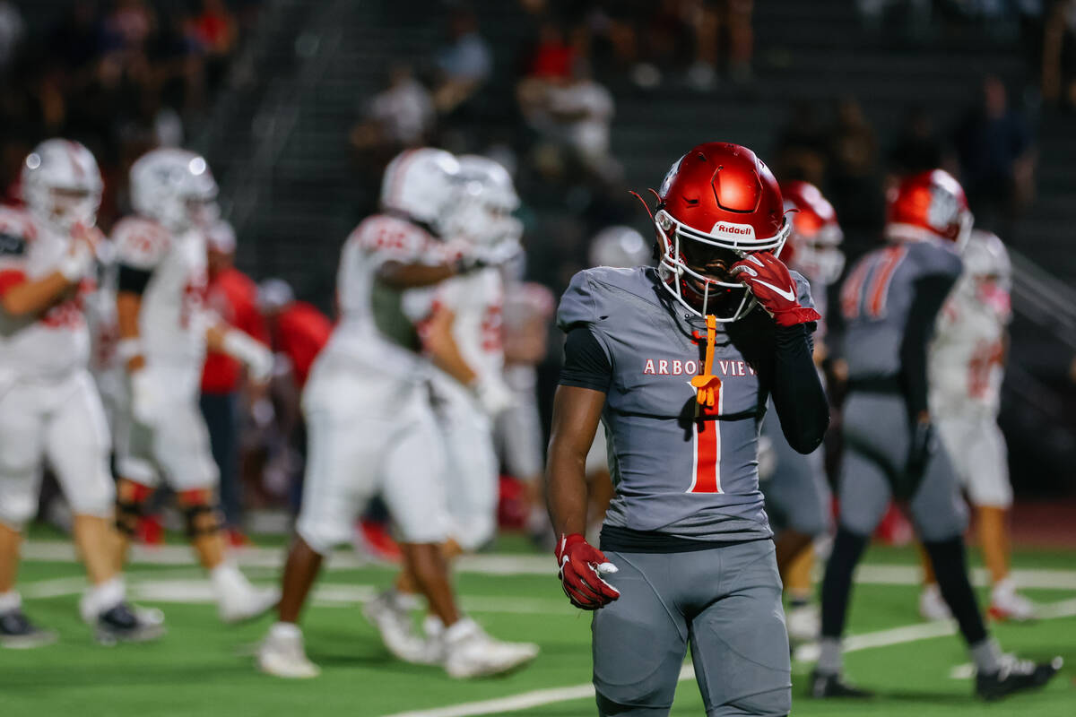 Arbor View cornerback Teddy Johnson (1) adjusts his helmet as he walks back to position during ...