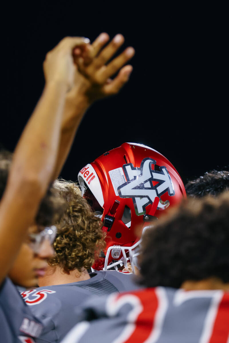 Arbor View players hold up hands and helmets for one last cheer after a football game on Friday ...