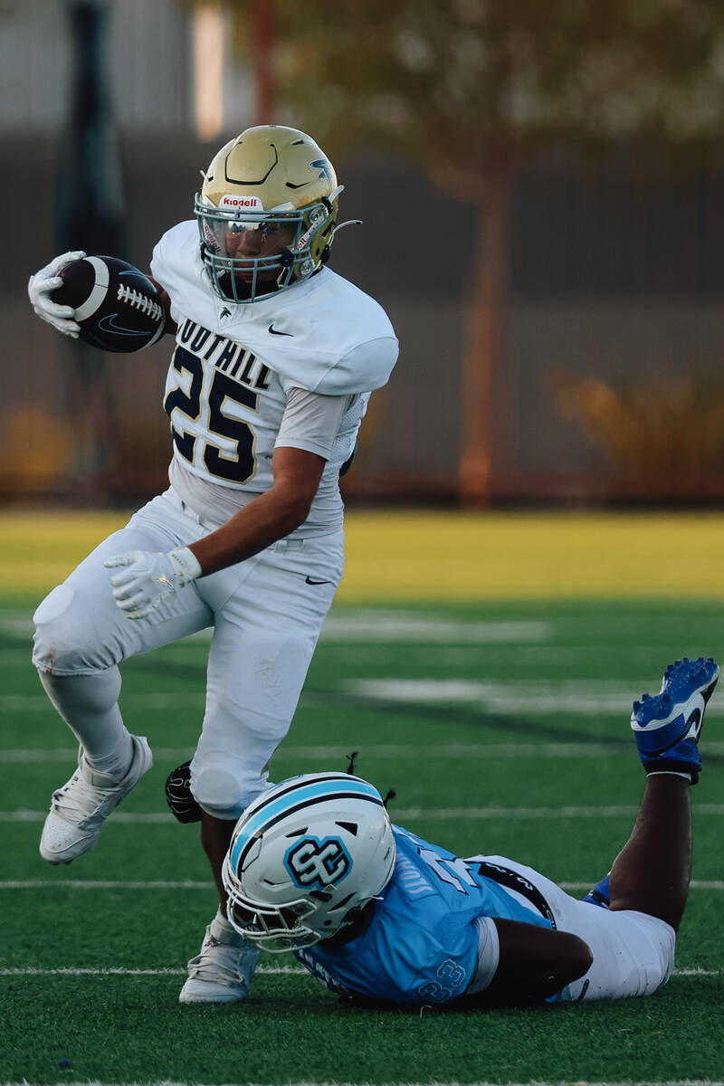 Foothill running back Robert Ledezma powers his way past an opponent during a high school footb ...