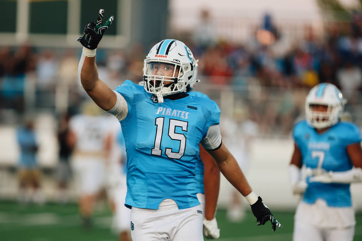 Sloan Canyon’s Gavin Rhodes (15) celebrates an interception during a high school footbal ...