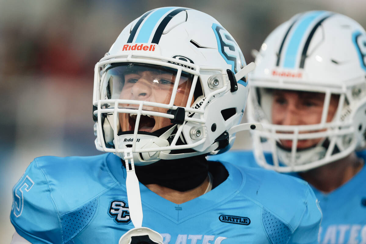 Sloan Canyon’s Gavin Rhodes (15) celebrates an interception during a high school footbal ...