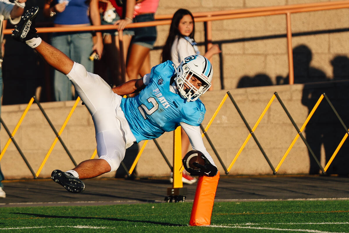 Sloan Canyon wide receiver Brandon Quaglio leaps for a touchdown during a high school football ...