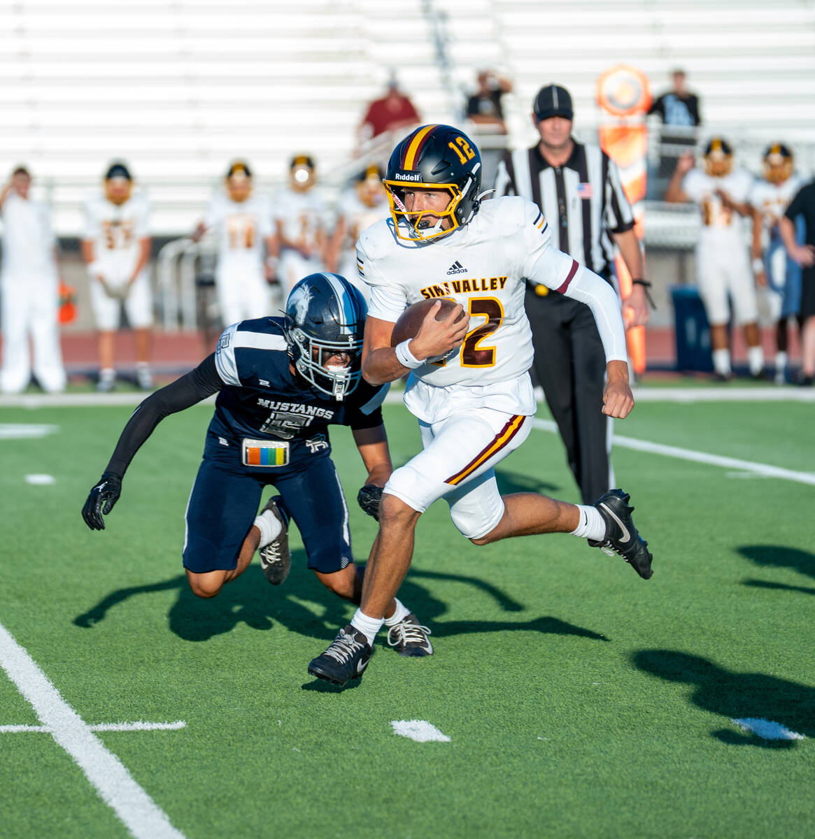 Simi Valley Quarterback Dawson Armstrong (12) avoids Shadow Ridge’s Isaiah Ruiz (5) duri ...