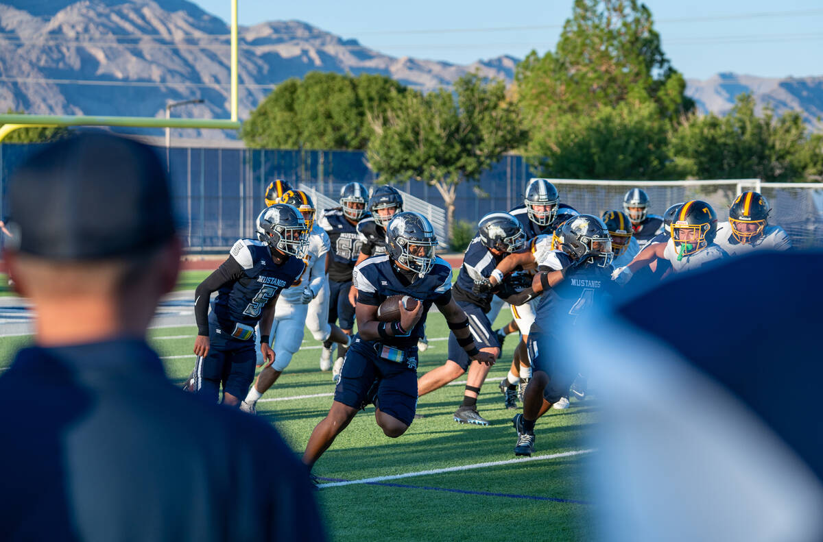 Shadow Ridge player Isaiah Jones (16) brings the ball upfield during the first quarter of a foo ...