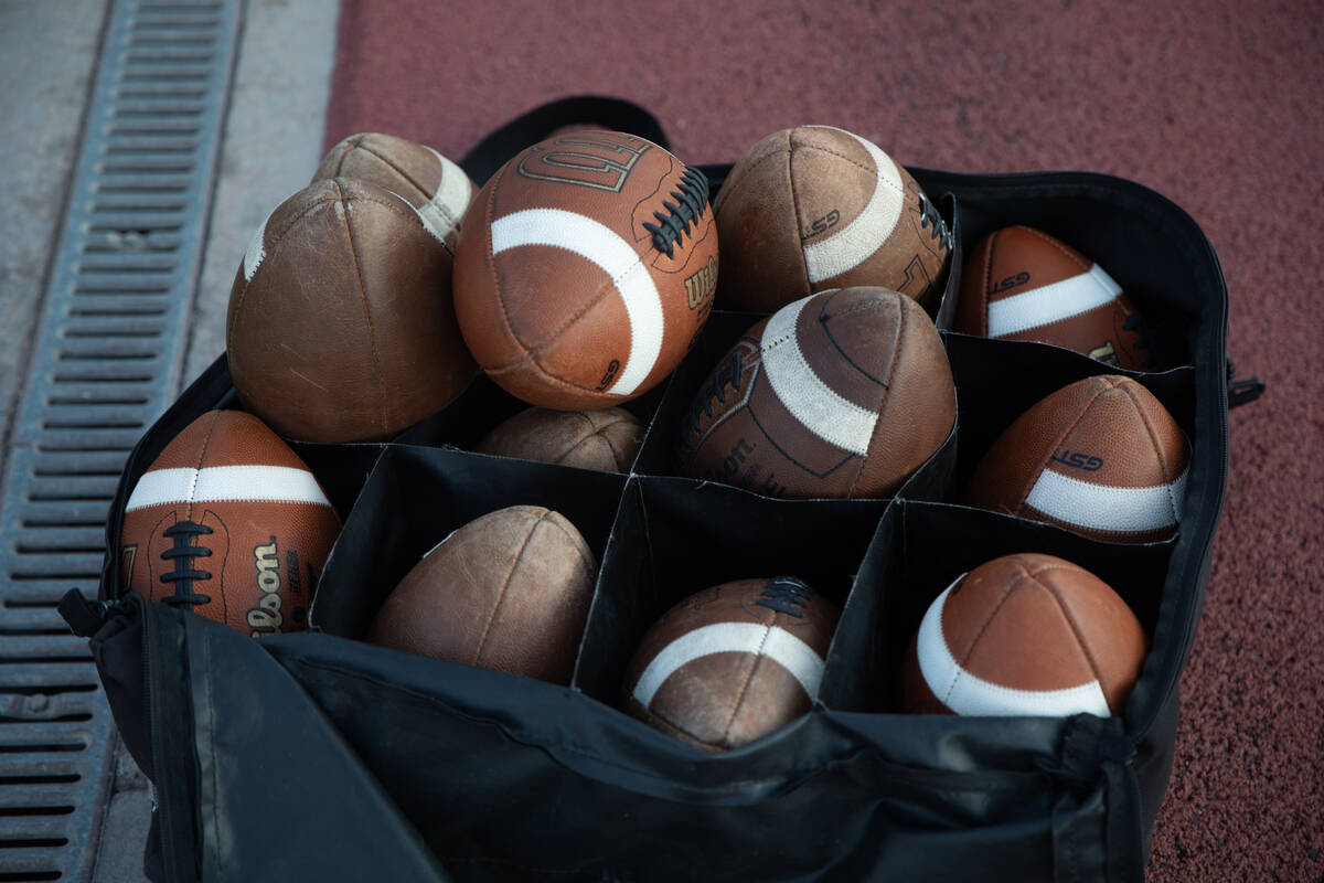 Extra footballs sit on the sidelines during a football game between Shadow Ridge and Simi Valle ...