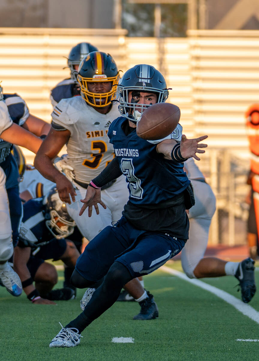 Shadow Ridge player Ula Cox (3) reaches for the ball during a football game between Shadow Ridg ...