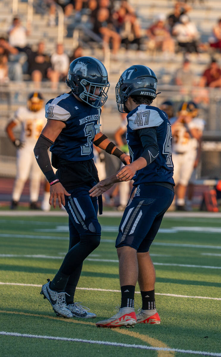Shadow Ridge players Ula Cox (3) and Jaxon Garcia (47) talk after a successful play during a fo ...