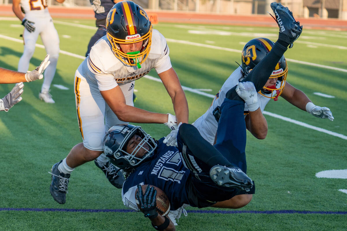 Shadow Ridge player Jokai Johnson (17) is taken down during the first quarter of a football gam ...