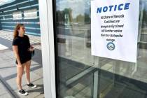 A woman arrives at the DMV office on East Sahara Avenue to find it closed on Tuesday, Aug. 26, ...