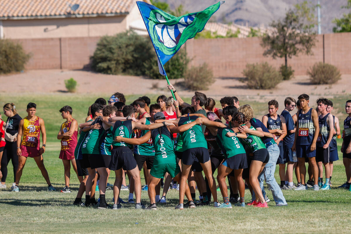Green Valley High School Cross Country team does a pre-race huddle chant before the Junior/Seni ...