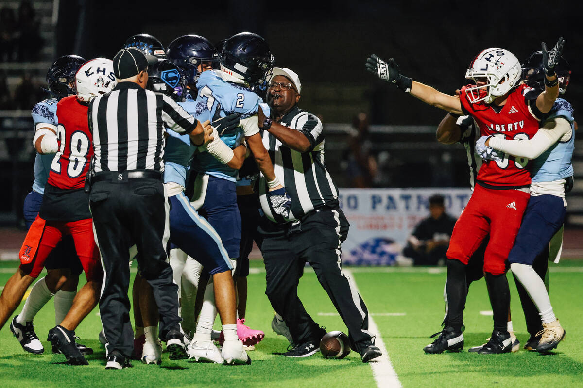 A fight breaks out during a high school football game between Kailua and Liberty at Liberty Hig ...