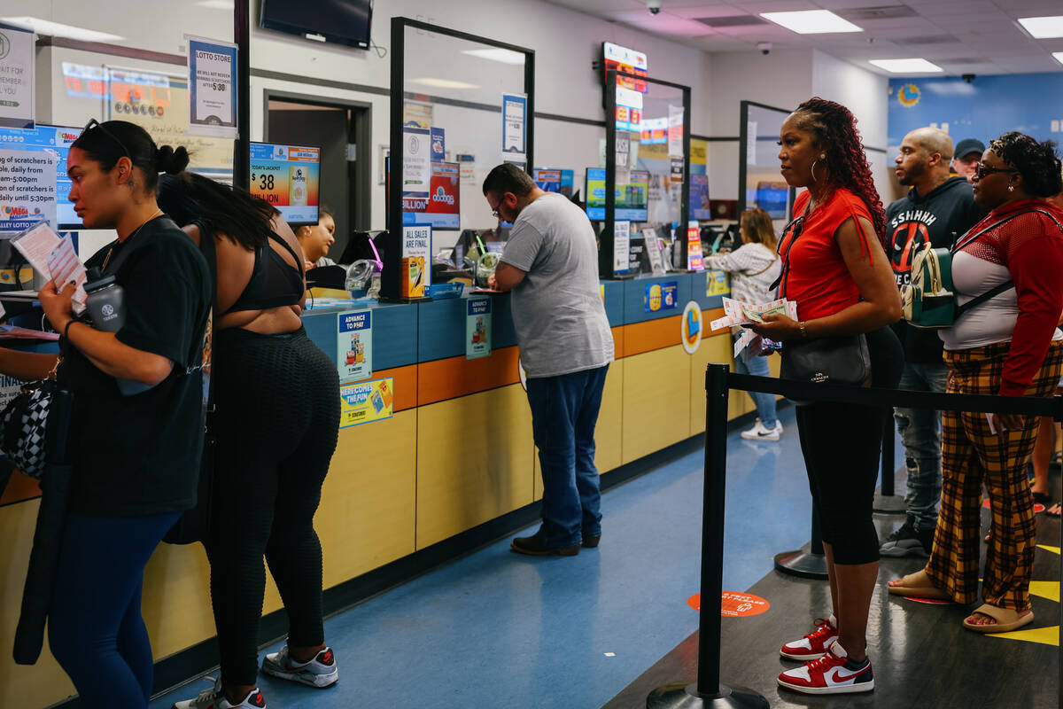 Waconda Ellis-Coleman, right, stands next in line to purchase lottery tickets on Saturday, Aug. ...