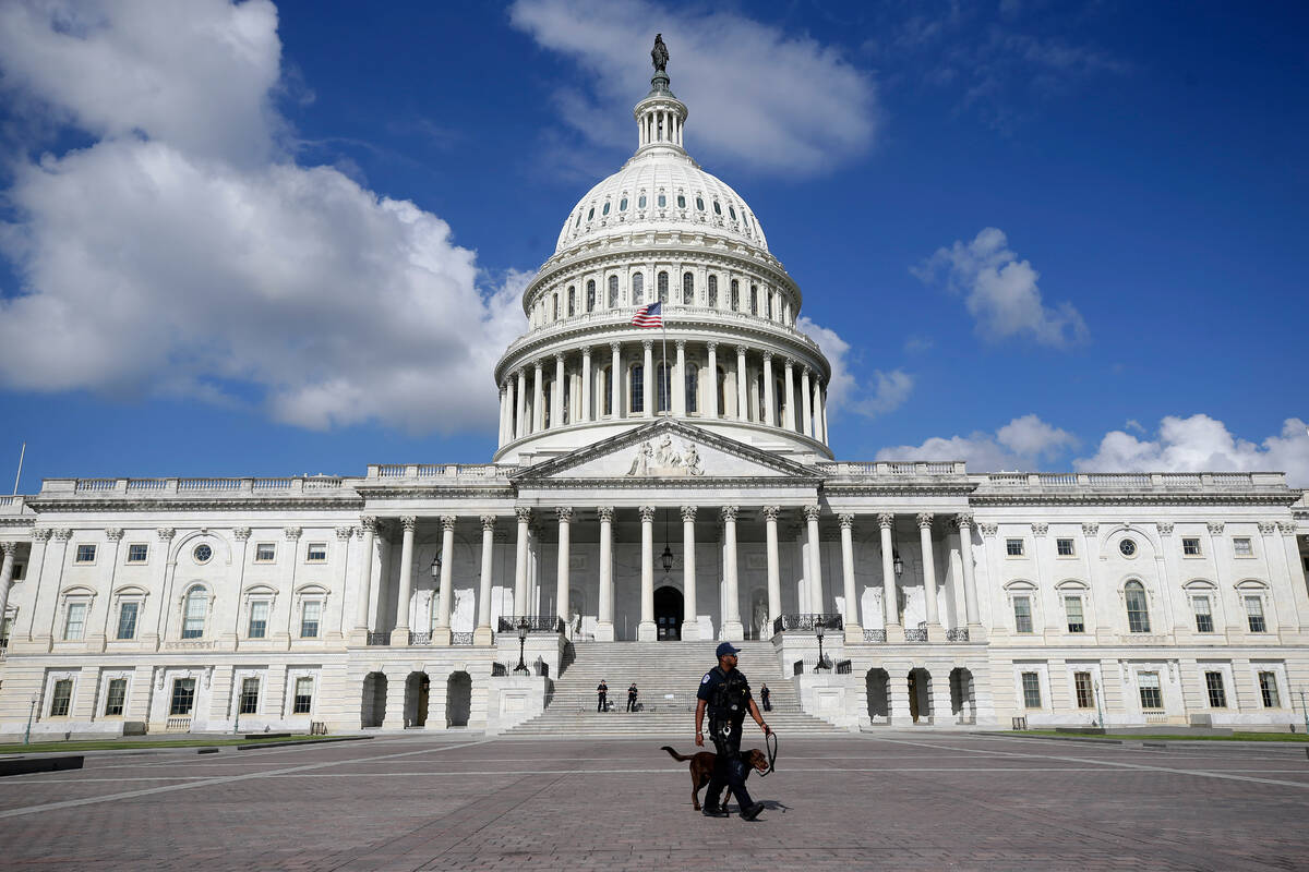 A U.S. Capitol Police officer walks in front of the U.S. Capitol, Aug. 22, 2025, in Washington. ...