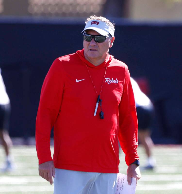 UNLV head coach Dan Mullen watches his players during the first day of football camp at the Fer ...