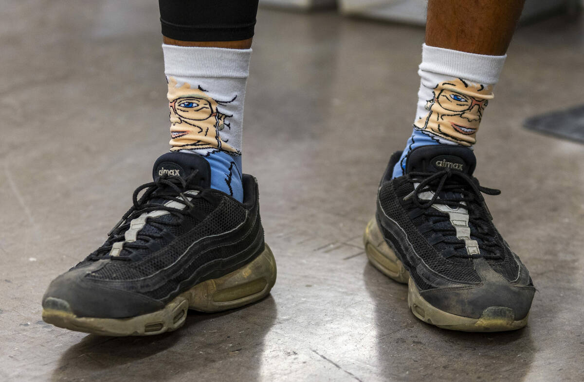 Ishe Smith wears a pair of Golden Girls socks as he sorts the mail he will deliver on his route ...