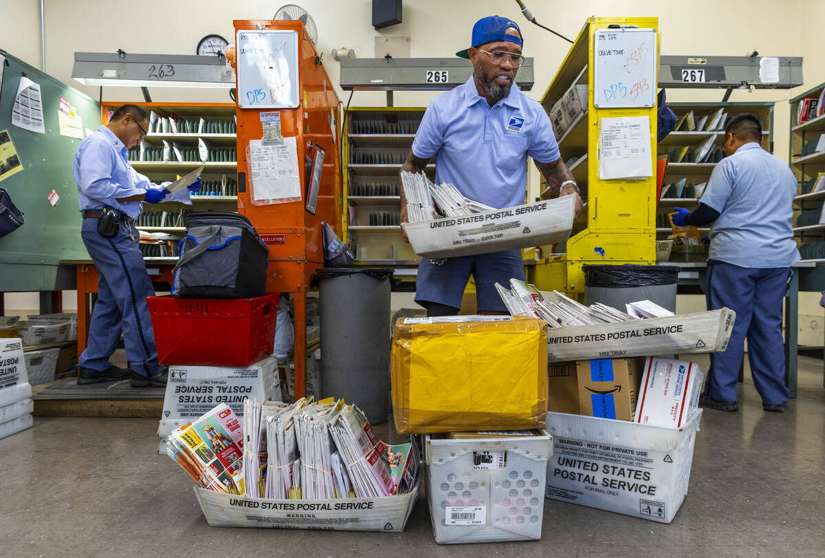 Ishe Smith gathers the mail he will deliver on his route as a mail carrier while starting his s ...
