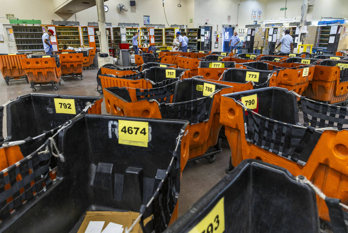 Ishe Smith and other gather the mail they will deliver on their routes as mail carriers while s ...