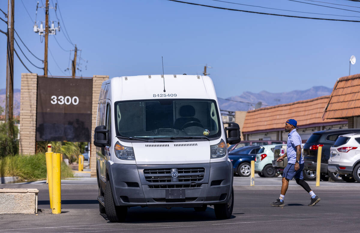 Ishe Smith makes a stop along his route as a mail carrier on Wednesday, July 30, 2025, in Las V ...
