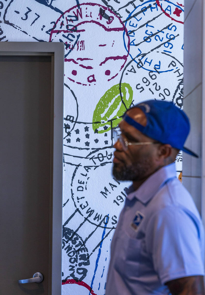 Ishe Smith waits for access to assigned lockers for residents as he makes an apartment stop alo ...