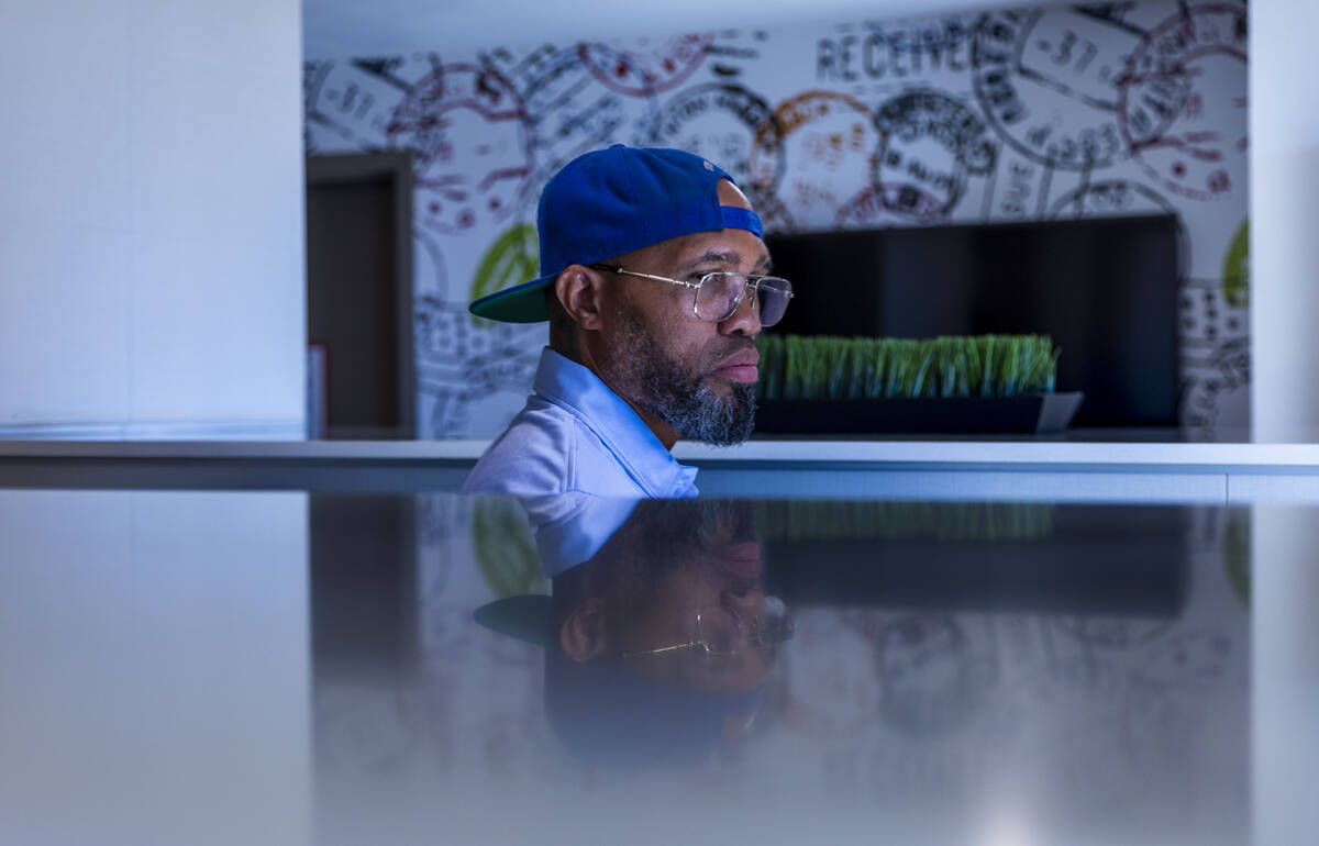 Ishe Smith delivers a resident's mail as he makes an apartment stop along his route as a mail c ...