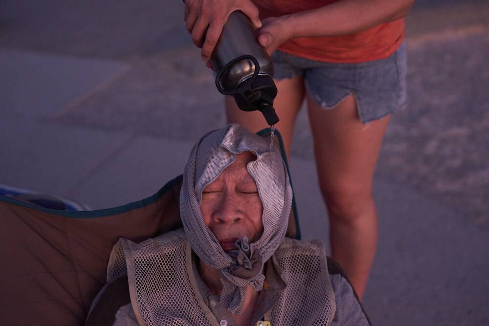 Grace Chyuwei pours water on Joe Chyuwei to help with the heat Sunday, Aug. 3, 2025, in Death V ...
