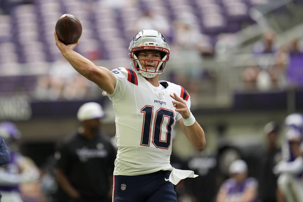 New England Patriots quarterback Drake Maye warms up before the start of a preseason NFL footba ...